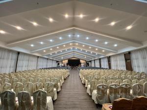 a large room with rows of chairs and a stage at Livingston Hotel in Sandakan +18 photos