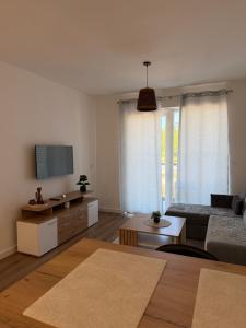 a living room with a couch and a tv at City Break Sarajevo in Sarajevo
