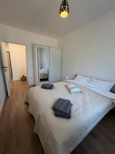 a bedroom with a large bed with two towels on it at City Break Sarajevo in Sarajevo