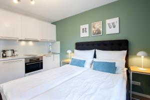 a bedroom with a large bed with blue walls at Sali Homes - Wahnfried No 1 City Apartment Balcony in Bayreuth