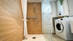 a shower in a bathroom with a washing machine at Studio La Parenthèse Sablaise - 3 étoiles in Les Sables-d'Olonne