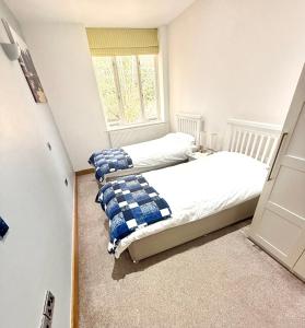 a bedroom with a bed and a window at Cromer Getaway luxury apartment in Cromer