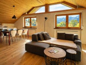 a living room with a couch and a table at Garage Loft in Satteins