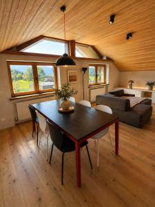 a living room with a table and a couch at Garage Loft in Satteins +28 photos