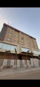 a large building with palm trees in front of it at Platinum Arc in Jaipur