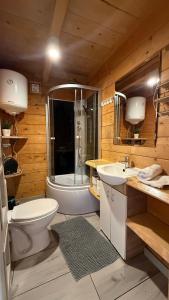 a bathroom with a toilet and a sink and a tub at Osada Kryspinów in Cholerzyn +57 photos