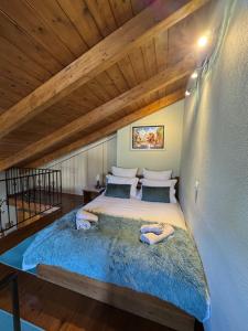 a large bed in a room with a wooden ceiling at Frigias 4 in Arachova