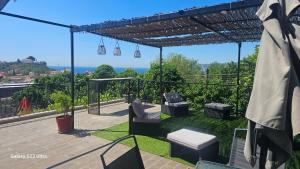 a patio with chairs and a pergola at Le soleil de l'estaque in Marseille