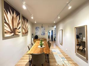 a dining room and living room with a table and chairs at Mujito5 15Pax 3BR NearTC, DinosaurLand, PS4 Netflix in Kuantan +11 photos