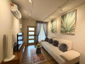 a living room with a couch and a flat screen tv at Mujito5 15Pax 3BR NearTC, DinosaurLand, PS4 Netflix in Kuantan