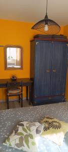 a bedroom with a bed and a cabinet and a table at appartement Anna in Parentis-en-Born