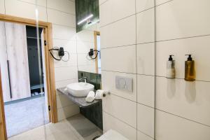 a bathroom with a sink and a mirror at Kryla by Shepilska in Dolgoluka +30 photos