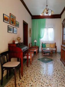 a living room with a piano and a couch at Filomeni's house in Kavála