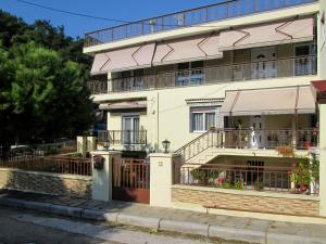 a large white building with balconies on a street at Filomeni's house in Kavála