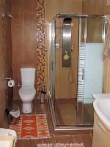 a bathroom with a shower with a toilet and a sink at Filomeni's house in Kavála +31 photos