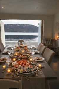 a long table with plates of food on it at Sea house in beautiful surroundings in Haram