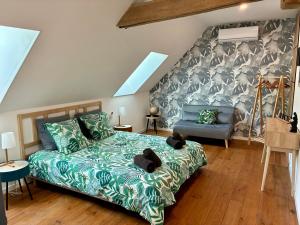 a bedroom with a green bed and a blue couch at Le domaine du Quercy in Padirac +26 photos