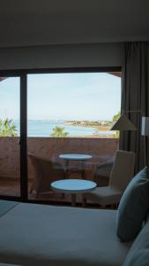a bedroom with a bed and a view of the beach at Hotel Bahia Sur in San Fernando