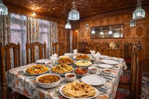 a table with many plates of food on it at Firdous Houseboats at Dal Lake in Srinagar +12 photos