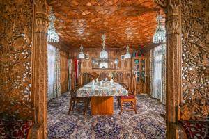 a dining room with a table and chairs in a building at Firdous Houseboats at Dal Lake in Srinagar