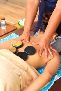 a woman getting a massage from a therapist at SAMADHI Resort & Hydrospa Panglao in Panglao Island