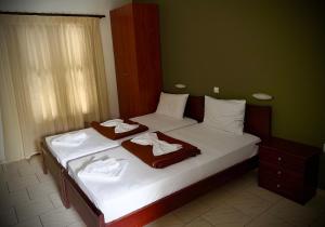a bedroom with two beds with towels on them at Kallisti in Ormos Panagias