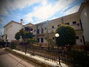 a black fence in front of a building at Kallisti in Ormos Panagias