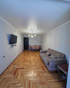 a living room with a couch and a flat screen tv at дом отдыха in Itʼkhvisi