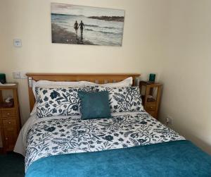 a bedroom with a bed and a picture on the wall at The Apartment in Nairn