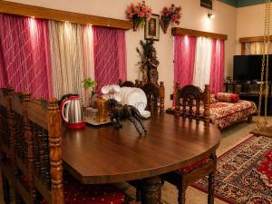 a living room with a table and a couch at The Timeless Mysuru bungalow in Mysore