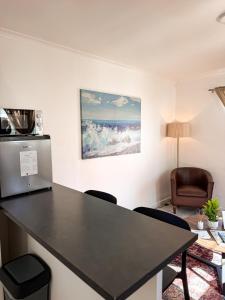 a desk in a room with a table and chairs at Paterson Place Studios in Hermanus