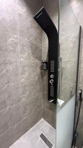 a shower with a glass door in a bathroom at شقق سدايم in Jeddah +19 photos