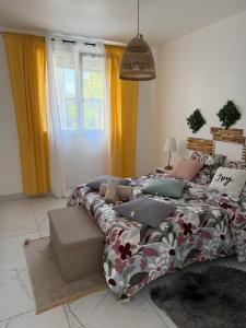 a bedroom with a bed and a window with yellow curtains at Le soleil de l'estaque in Marseille