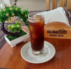a drink sitting on a plate on a table at Kilimanjaro Magic in Moshi