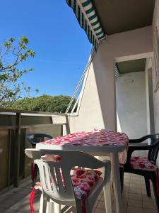 a table and chairs on a balcony with a roof at CORALLO 31 con Piscina in Lido delle Nazioni