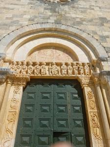 a building with a green door with statues on it at Villetta di Laura in Villa San Leonardo