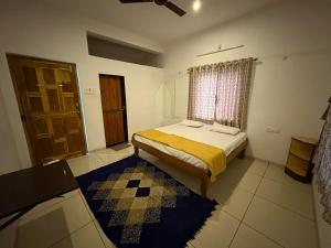 a bedroom with a bed and a window and a door at Green Valley Resort in Thāl +17 photos