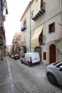 a white van parked on the side of a street at Vanni House 68 in Cefalù