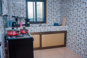 a kitchen with two pots and pans on a stove at Résidence Maranatha in Cotonou