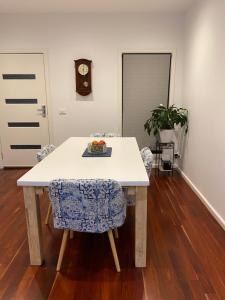 a table and chairs with a plate of fruit on it at Eastern Suburbs Gem in Forest Hill +3 photos