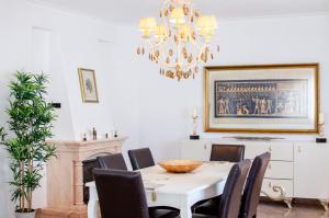 a dining room with a table and chairs and a chandelier at Villa Brisa do Mar by Algarve Holidays in Galé