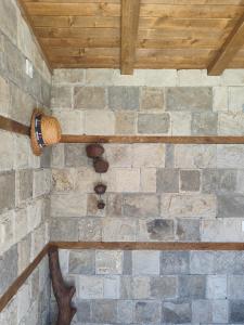 a stone wall with a barrel on the wall at "Goritsa" Guest House , Къща за Гости "Горица" in Ovchartsi +14 photos