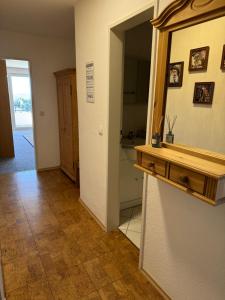 a hallway with a mirror and a sink in a room at FeWo Luisa in Neureichenau +11 photos