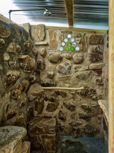 a stone wall with some green buttons on it at Green Nomad in Hogsback