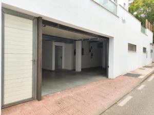 an open garage door of a white building at Chill and Beach in Torremolinos