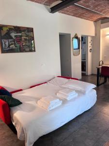 a bedroom with a white bed with towels on it at Casa Barovaldo in Zola Predosa
