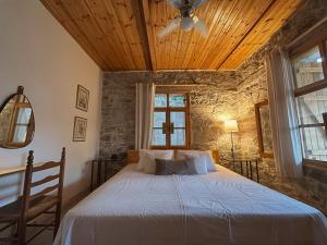 a bedroom with a bed with a wooden ceiling at Eria Moutoullas House in Moutoullas