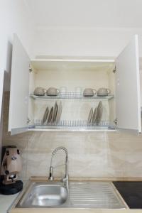 a kitchen with a sink and utensils at Dimora Don Ferdinando in Naples