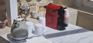 a counter top with a coffee maker and utensils at Suite Majorelle du Château in Gaillan-en-Médoc