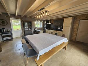a bedroom with a large bed and a kitchen at Villa nest in Saint-Sauvant